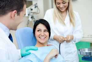 female patient in dental chair talking to dentist new dental patient Greenbelt, MD